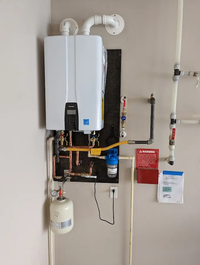 Professional plumber installing copper piping in a Deer Park home